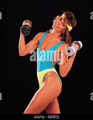 Indoor close-up of young woman.  Weight training. Stock Photo