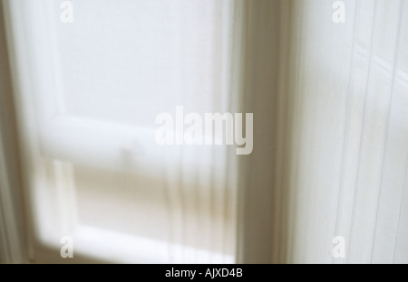 Net curtain in front of half opened sash window Stock Photo