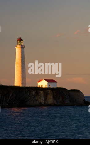 Lighthouse at Cap-des-Rosiers in evening light, Forillon National Park, QC Quebec, Canada Stock Photo