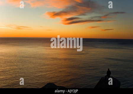 Pre-dawn skies over the Gulf of St. Lawrence, with human figure, Forillon National Park, QC Quebec, Canada Stock Photo