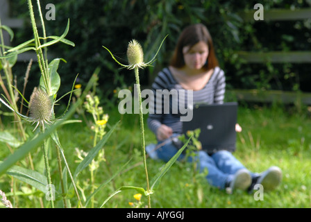 Young Woman works on laptop with Wireless internet connection Stock Photo
