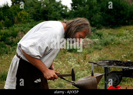 Blacksmith at work at market in Devin castle, Slovakia. Stock Photo