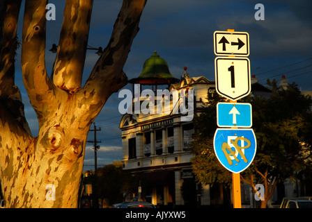 last light of sunset shines on highway street sign, sugar gum and Guildford hotel in background. Guildford, Western Australia Stock Photo