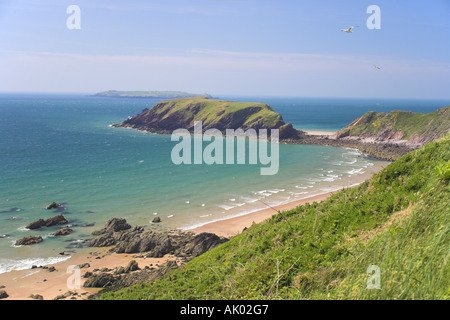 Gateholm and  Skokholm Island beyond at Marloes Sands with seagulls in fligth Stock Photo