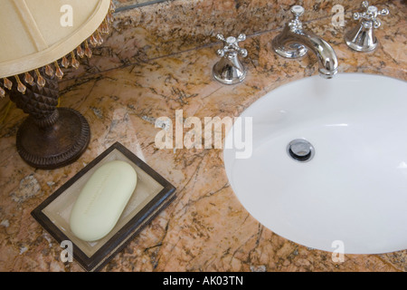 Detail of bathroom sink with chrome faucet and soap dish