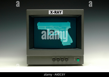 Video surveillance monitor showing an x ray of an automatic handgun Stock Photo