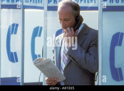 businessman talking on pay phone Stock Photo
