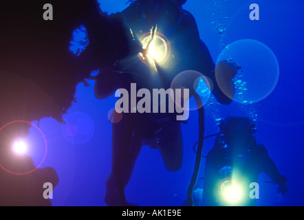 skin divers exploring underwater cave in Florida USA Stock Photo