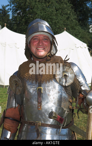 Closeup of man in suit of shining armour holding pike at medieval reenactment Stock Photo