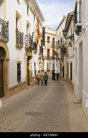 Two families walking down one of the tyically narrow, winding streets in Ronda, Spain.