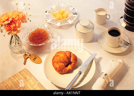 Breakfast setting with coffee and croissant. Stock Photo