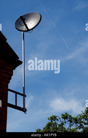 Satellite dish antenna  attached to the side of a house. Stock Photo