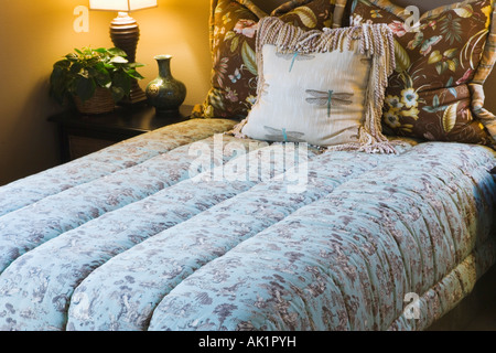 Comfortable Double Bed with Comforter Stock Photo