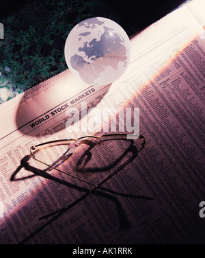 Still life business concept. Spectacles & glass globe. Stock Photo