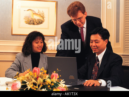 Three people in office meeting. Stock Photo