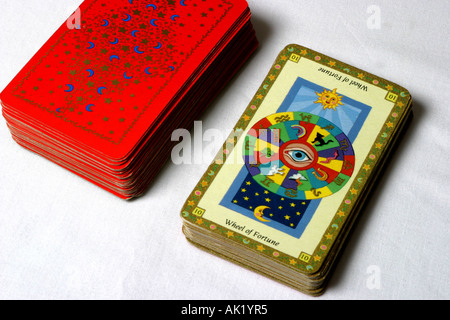 The Wheel of Fortune card and a pack of tarot cards. Stock Photo