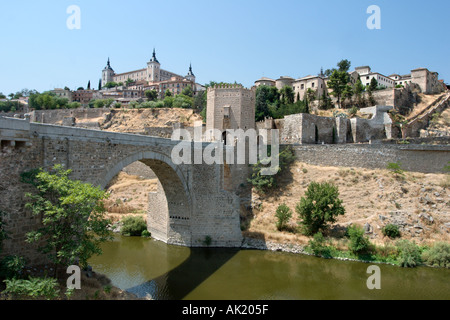 The Puerta de Alcantara on a bridge over the River Tagus with the Alcazar behind, Toledo, Castilla-La-Mancha, Spain