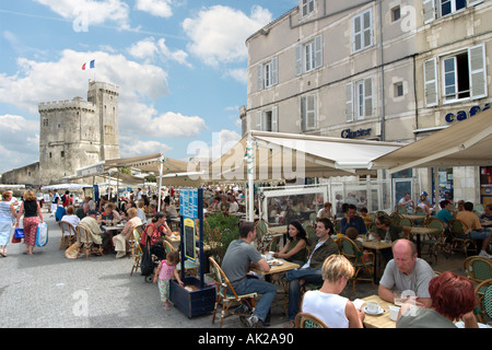 Pavement cafe in the Vieux Port with the Tour St Nicolas behind, La Rochelle, Poitou-Charentes, France Stock Photo