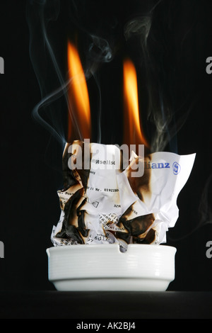 Insurance policy burning up Stock Photo
