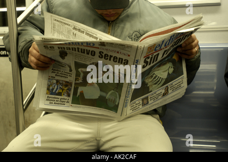 Reading NY Newspaper subway horizontal Stock Photo