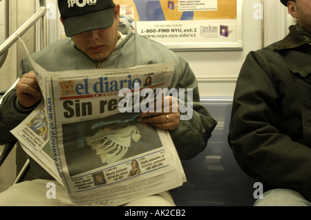 Reading NY Newspaper subway horizontal Stock Photo