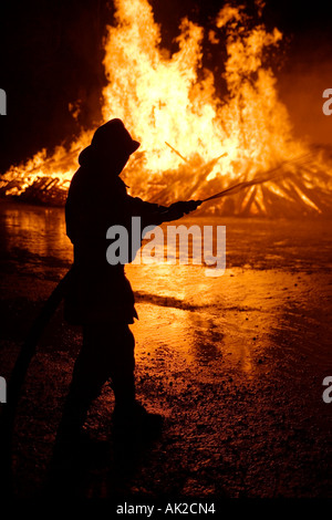 Swiss national-holiday, 1. August-fires, the fire is monitored by the fire brigade, Tentlingen, canton Freiburg, Switzerland Stock Photo