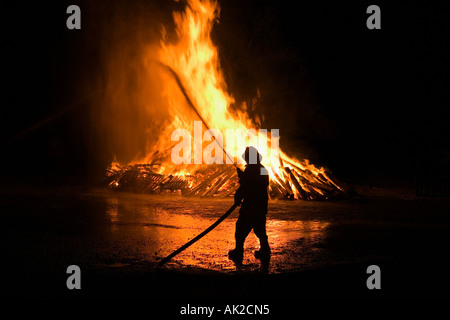 Swiss national-holiday, 1. August-fires, the fire is monitored by the fire brigade, Tentlingen, canton Freiburg, Switzerland Stock Photo