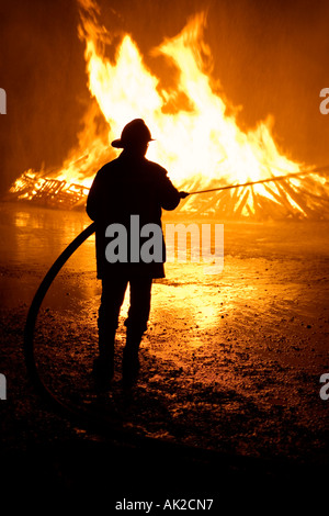 Swiss national-holiday, 1. August-fires, the fire is monitored by the fire brigade, Tentlingen, canton Freiburg, Switzerland Stock Photo