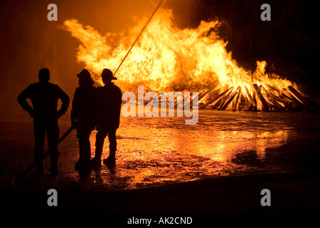 Swiss national-holiday, 1. August-fires, the fire is monitored by the fire brigade, Tentlingen, canton Freiburg, Switzerland Stock Photo