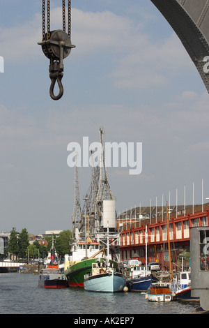 Bristol historic harbour old boats and steam tugs moored alongside the Princes Wharf with dockside crane jib summer 2006 Stock Photo