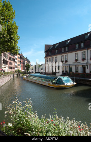 Tour boat in front of the lock gates on the River Ill in Petite France near the city centre, Strasbourg, Alsace, France Stock Photo