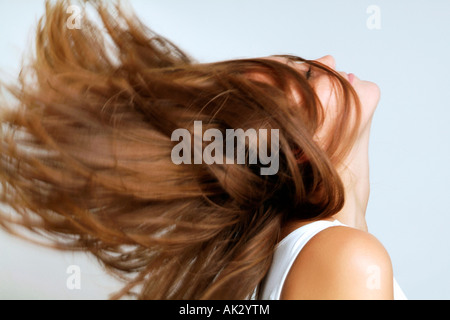Young woman swinging her hair back Stock Photo