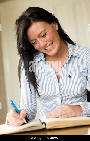 Girl writing in diary Stock Photo