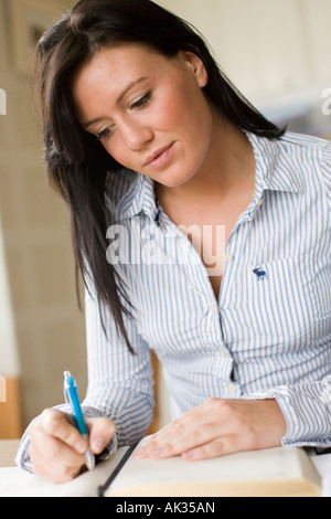 Girl writing in diary Stock Photo