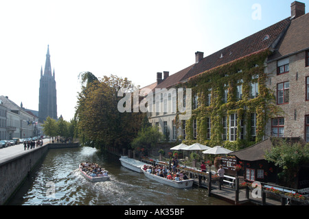 View along canal in the city centre looking towards Onze Lieve Vrouwekerk church, Bruges (Brugge), Belgium Stock Photo