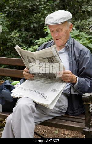 Old man sitting on a park bench Stock Photo - Alamy
