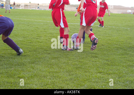 Girls playing soccer on green field outdoors in the Spring. Stock Photo