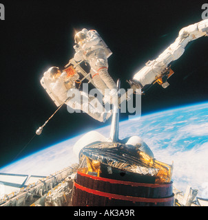 Space exploration. NASA Astronauts D. Gardner & J. P. Allen IV in space, holding joke "For Sale" sign. Stock Photo