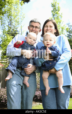 A mother and father with twin babies Stock Photo