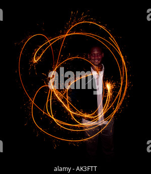 Man playing with a sparkler. Stock Photo