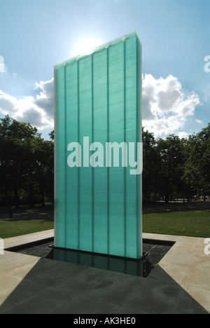 Controversial National Police Memorial formed of a glass column with sun backlighting on a blue sky sunny day at Horse Guards Road London England UK Stock Photo