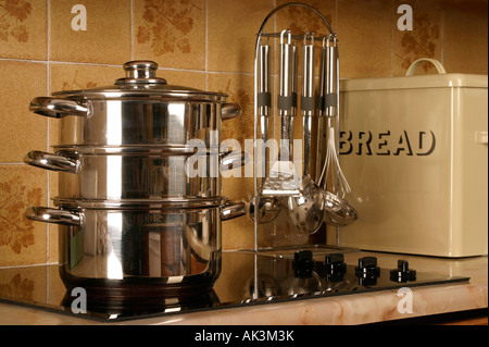 Steamer Saucepans cooking food on an electric hob Stock Photo