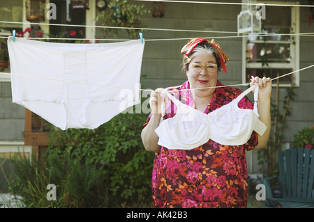 Woman hanging oversized underwear on a clothesline Stock Photo - Alamy