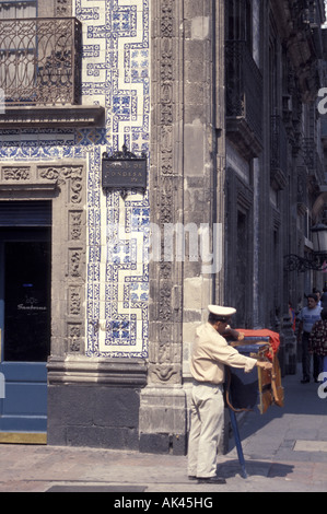 Organ grinder outside the Casa de los Azulejos or House of Tiles in downtown Mexico City Stock Photo