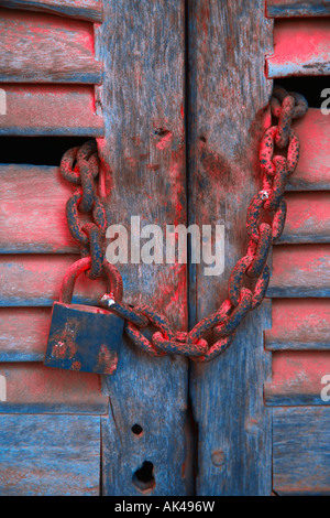 Padlock and chain on wooden door Stock Photo