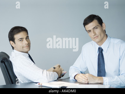 Business colleagues working together, smiling at camera Stock Photo