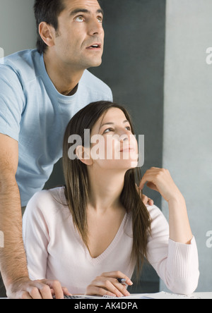 Couple looking up together, smiling Stock Photo