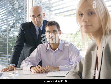 Three business executives in office, looking at camera Stock Photo