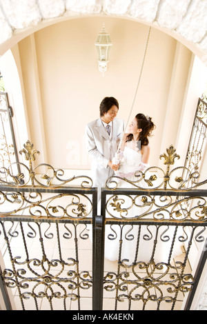 Bride and groom pulling on bell, top angle view Stock Photo