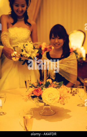 Bride and groom lighting a candle. Close-up Stock Photo